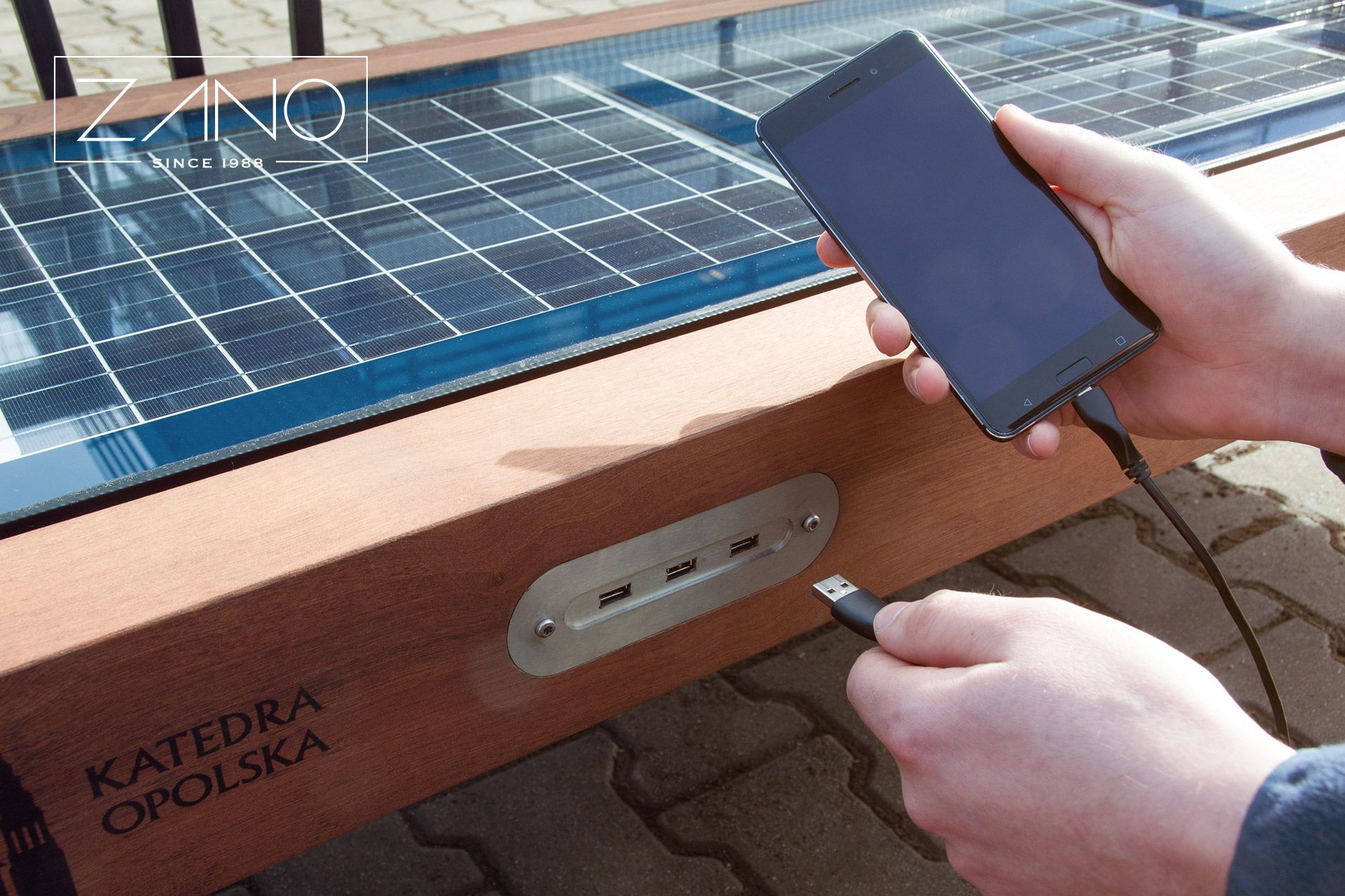 City bench with three charge ports for mobile phones
